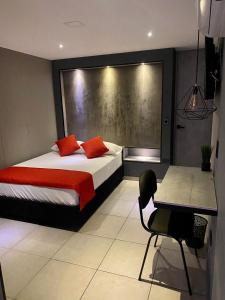 a bedroom with two beds and a table and a desk at Hotel BRC in Bucaramanga