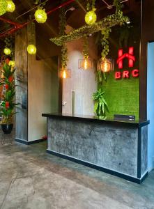a lobby with a bar with lights on the wall at Hotel BRC in Bucaramanga