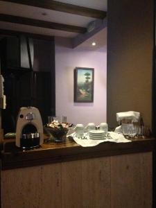 a kitchen counter with a mixer and dishes on it at Hotel El Maño in Huéscar