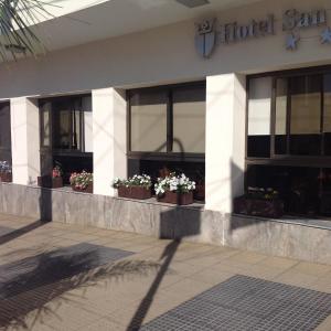 a hotel building with potted plants on the windows at Hotel San Carlos in Termas de Río Hondo