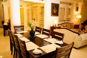 a dining room with a table and a couch at Kandy view resort in Kandy