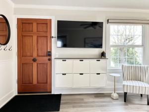 a living room with a white dresser and a door at Modern 2 Bedroom Farmhouse Cottage with Hot Tub in Snohomish in Snohomish