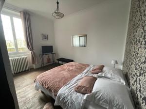 a bedroom with a bed with pillows on it at Le Domaine de la Garenne in Épinac-les-Mines +21 photos