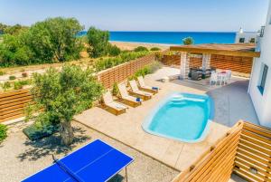 a backyard with a pool and a hot tub at Dias in Gennadi