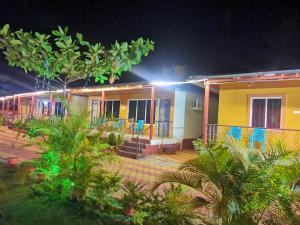 ein Haus in der Nacht mit Lichtern in der Unterkunft Shivshrushti Agro Tourism & River Camp Tapola in Mahabaleshwar