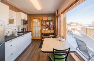 a kitchen with a table and a large window at Aurora Bayside Inn in Yellowknife +50 photos