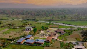 an aerial view of a house in a field at Green Chwadi Nature Retreat in Kawasoti