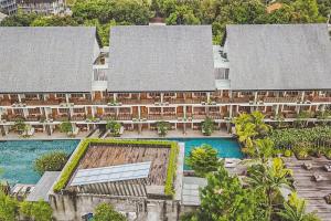 an aerial view of a resort with a swimming pool at Swarga Suites Bali Berawa in Canggu
