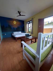 a bedroom with a bed and a table and a couch at Green Chwadi Nature Retreat in Kawasoti