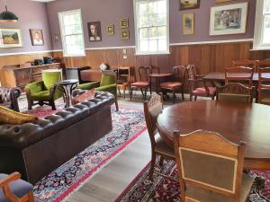 a living room with a couch and tables and chairs at Ratho Farm in Bothwell