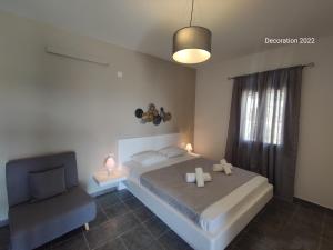 a bedroom with a bed and a chair in it at Marianthi Studios in Áno Meriá