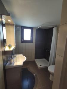 a bathroom with a sink and a toilet at Marianthi Studios in Áno Meriá