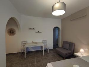 a living room with a table and a chair at Marianthi Studios in Áno Meriá