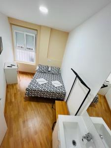 a room with a bed and a sink in it at Hospedaje Puente de Vallecas in Madrid