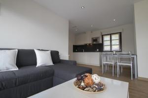 a living room with a couch and a table at Apartamentos Andrin in Andrín