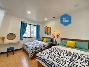 a room with two beds and a sign that reads tourist museum at Hue Crown Boutique best hotel in Hue