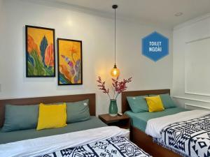 a room with two beds and a sign that reads tourist museum at Hue Crown Boutique best hotel in Hue