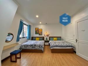 two beds in a room with a sign that reads tourist museum at Hue Crown Boutique best hotel in Hue