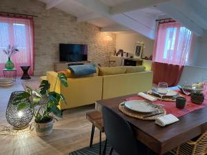 a living room with a table and a couch at Lovely apartment in Périgueux in Périgueux
