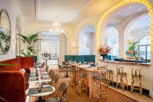 a restaurant with tables and chairs and a bar at Holiday Inn Paris - Gare de Lyon Bastille, an IHG Hotel in Paris