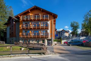 a building with balconies on the side of it at Holiday Family Raj Pod Sosnami in Szklarska Poręba