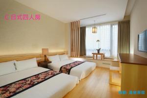 A bed or beds in a room at Green Life Spa Hot Spring Hotel