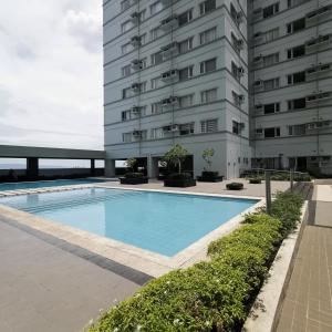 a swimming pool in front of a building at Avida Davao Condos, downtown CM Recto Avenue, Davao City in Davao City