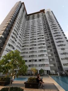 two people sitting in front of a large apartment building at Avida Davao Condos, downtown CM Recto Avenue, Davao City in Davao City +37 photos