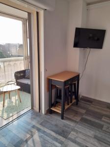 a small table in a living room with a television at Studio type T1 avec parking et cave à 600 m de la plage in Fréjus