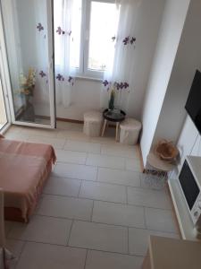 a room with a bed and a window and a mirror at Agata Apartments in Novalja