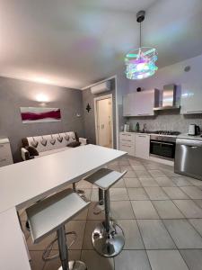 a kitchen with a white table and a couch at Appartamento Emerald in Sirmione