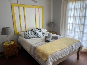 a bed with two pillows on it in a bedroom at Kosy place in KwaMazambane