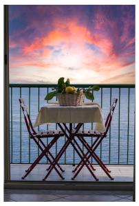 a basket of fruit sitting on a table on a balcony at Casa Colombo in Vietri sul Mare