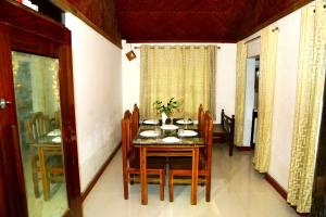 a dining room with a table and chairs at VALENTINE'S RICE BOWL HOME STAY in Alleppey