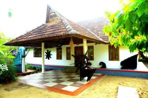 a house with a checkered floor in front of it at VALENTINE'S RICE BOWL HOME STAY in Alleppey