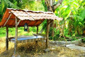 a small hut with a roof on top of it at VALENTINE'S RICE BOWL HOME STAY in Alleppey
