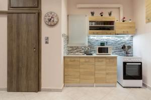 A kitchen or kitchenette at Sirens Athens Apartment