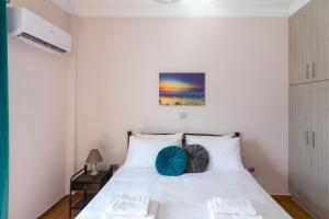 A bed or beds in a room at Sirens Athens Apartment