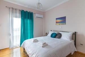 A bed or beds in a room at Sirens Athens Apartment