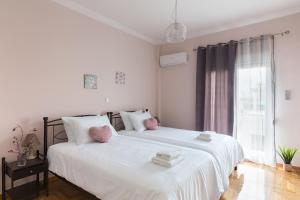 A bed or beds in a room at Sirens Athens Apartment