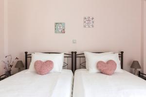 A bed or beds in a room at Sirens Athens Apartment