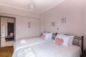 A bed or beds in a room at Sirens Athens Apartment