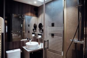 a bathroom with a sink and a shower at Hotel Le Dauphin in Honfleur
