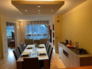 a dining room with a long table and chairs at Appartement chic au centre HUT 08087 in Escaldes-Engordany