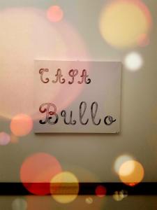 a sign on a wall with the word bille at Casa BuIIo in Chioggia