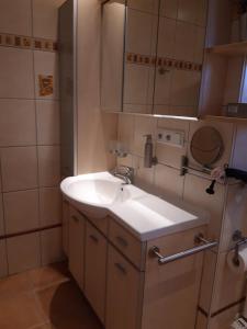 a small bathroom with a sink and a mirror at FeWo Marionette Hirschberg Lahn in Hirschberg +45 photos