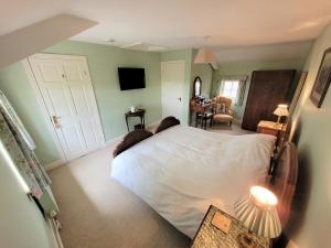 a bedroom with a large white bed in a room at Burton Grange Farmhouse Bed and Breakfast in Boroughbridge