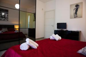 a hotel room with a bed and a television at Etna Catania Center in Catania