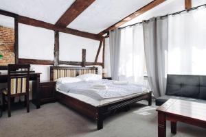 A bed or beds in a room at Hotel Legenda