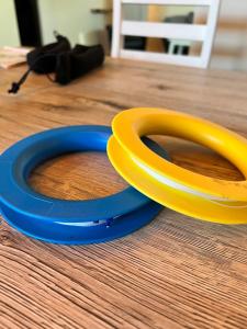 a pair of yellow and blue handles on a wooden floor at Lagertha - Maisonette in Büsum